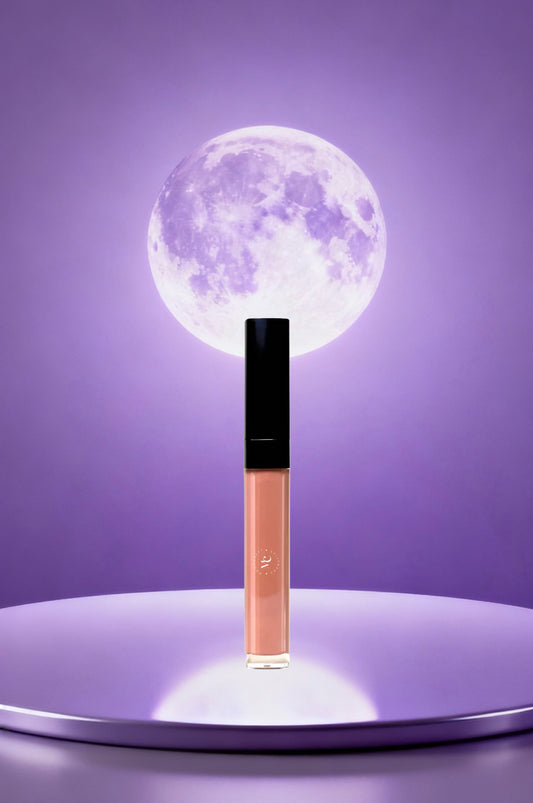 Lip gloss with a moon-like design on a purple background